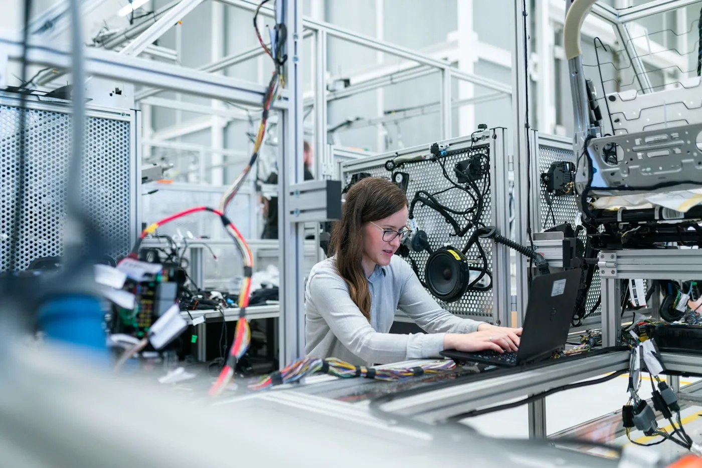 Manufacturing technician inspecting a production line with a tablet.