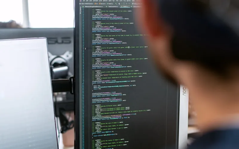 Technician's hands on a control panel of a CNC machine.